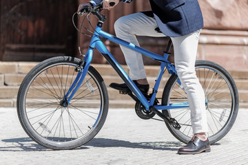 Stylish male person riding bike