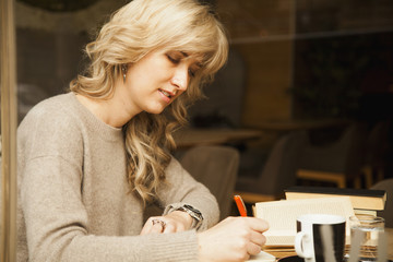 young beautiful girl is preparing for exam (Education, knowledge, exam, success concept)