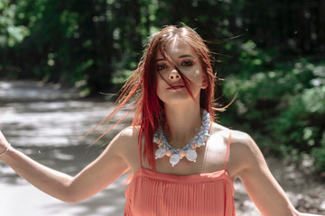 Naklejka premium young beautiful woman walking in the woods