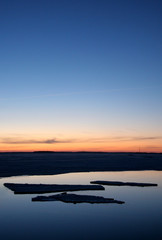 Ice floes on the river under the setting sun
