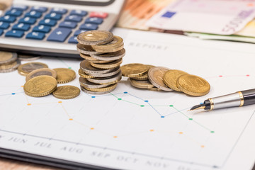 business graph with euro coin, banknote and calculator