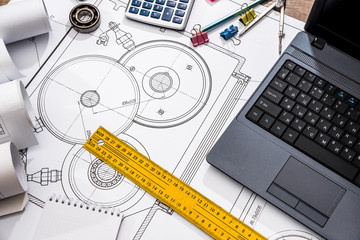 mechanical engineering of parts with tools, laptop, drawing top
