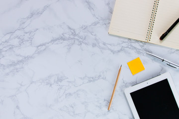 Modern mock-up flat lay of notebook and tablet on white marble texture background - Work space concept