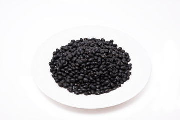 Fototapeta na wymiar Seed Black bean in white plate on the white background