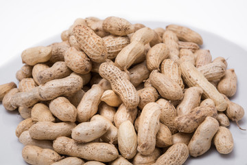 Dried peanuts on white plate at on white background