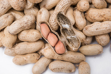 Dried peanuts on white plate at on white background