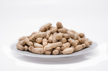 Dried peanuts on white plate at on white background