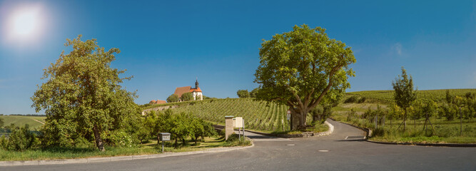 Fototapeta premium Panorama and sunny view to a bavarian church in the vineyards