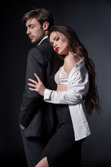 young sexy woman hugging handsome man in suit