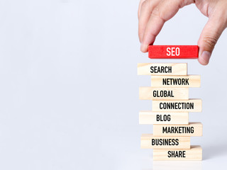 Businessman Building SEO concept with Wooden Blocks