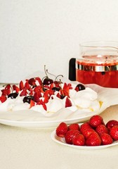 Cake Pavlova, strawberry, fruit ice tea on white.