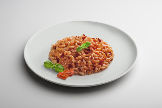 Risotto dish with dried tomatoes and basil