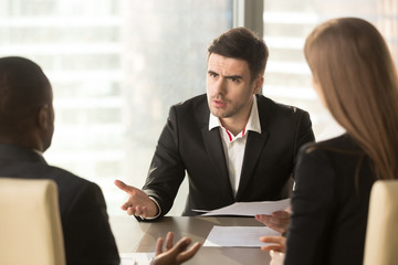 Angry boss dissatisfied with bad work result, displeased businessman holding contract arguing with contractor, demanding termination, loss compensation, defrauded cheated investor protecting rights