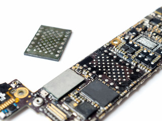 Close-up image of smartphone logic board removed flash storage (NAND) on white background