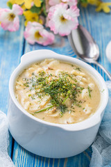 Tasty mushroom soup with noodles on a wooden table.