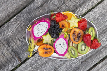 Fresh fruit salad on a grey wooden table