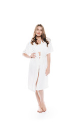 Beautiful woman in housecoat standing barefoot and looking at camera isolated on white