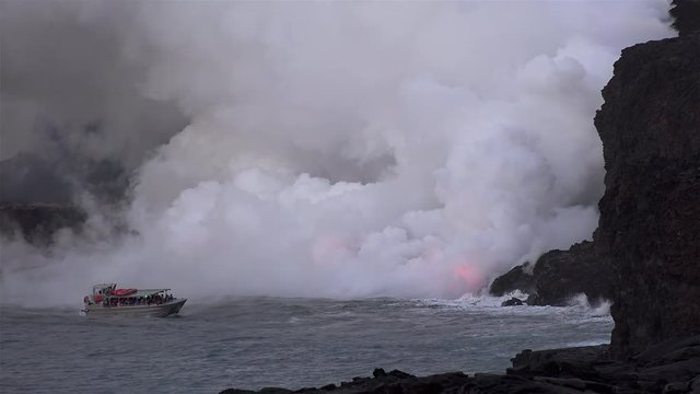 Hawaiian Boat Tour at the scenic point of Lava flowing into the ocean. Big Island, USA.