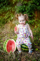 Cheerful baby eats a juicy watermelon. Vegetarian. The concept of child development and healthy food.