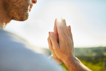 Closeup of man meditating doing joga exercise outdoors