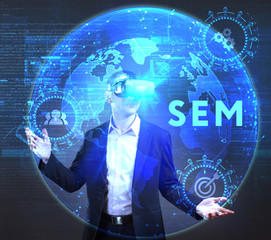 The concept of business, technology, the Internet and the network. A young entrepreneur working on a virtual screen of the future and sees the inscription: SEM