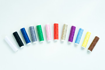 Spools of colours threads or call yarns on rolls for sewing isolated on white background