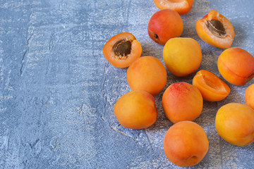 Fresh, juicy apricots on a concrete gray background. Bio food.