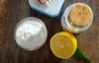 Tools with lemon and sodium bicarbonate on wood