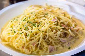 Spaghetti Carbonara served on white plate. Soft Focus.