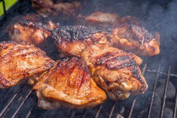 Grilled chicken thigh on the grill