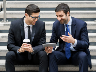 Two businessmen talking outdoors