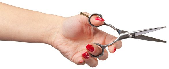 the hand of a Barber holding a scissors