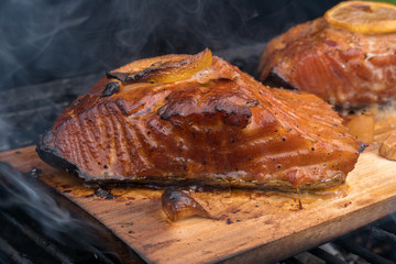 cedar plank salmon with lemon on a grill