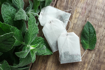 White tea bags with mint leaves