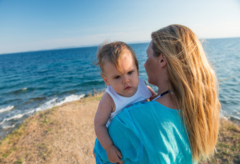 Fototapeta na wymiar Mom and child on beach, holiday background