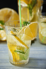 Glass of fresh lemonade on table