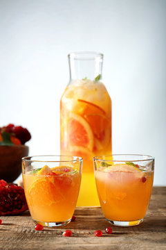 Two glasses of fresh citrus cocktail on table