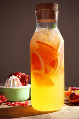 Decanter of fresh citrus cocktail on table