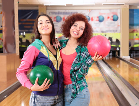 Friends having fun and playing bowling