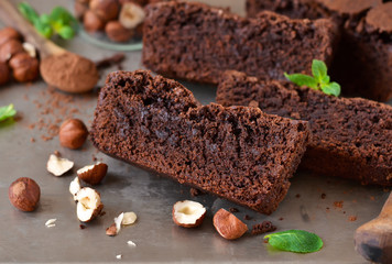 Homemade chocolate brownies with nuts on a metal, grunge background