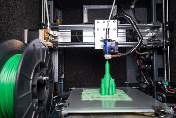 3d printer prints the model of the spaceship, the process of printing the spaceship on the 3d...