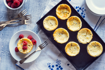 Passionfruit Cheesecakes with Raspberries on Table