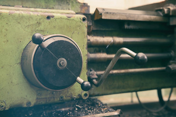 Part of turning machine for metalworking in shop, close up