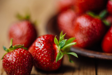 Strawberries on a plate on a wooden table