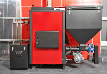 Solid fuel boiler against red wall