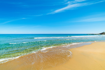 Fototapeta na wymiar Golden sand and turquoise water in Orri beach
