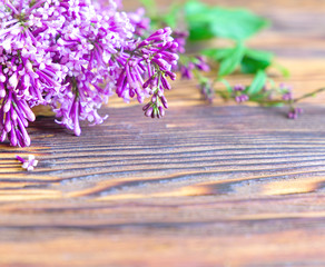 The beautiful lilac on dark wooden background