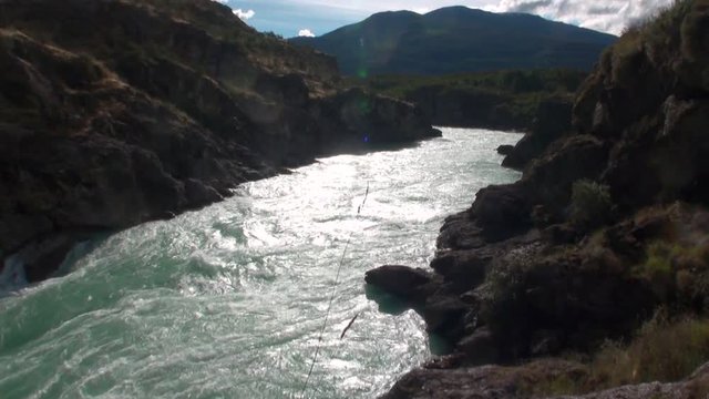 Mountain river show power water in Patagonia Argentina. Unique landscape of wildlife. Beautiful nature background. Travel and tourism in picturesque world of stone rocks and hills.