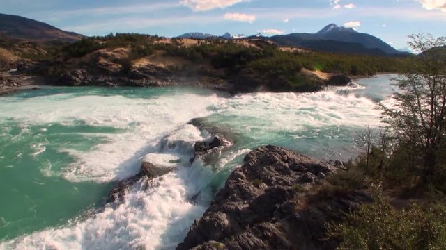 Rapids of mountain river show power water in Patagonia Argentina. Unique landscape of wildlife. Beautiful nature background. Travel and tourism in picturesque world of stone rocks and hills.