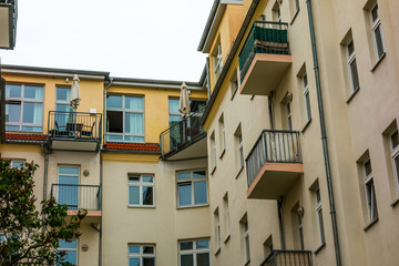 Fototapeta na wymiar orange apartment houses at Friedrichshain with balconies